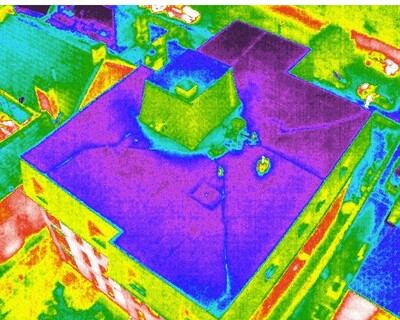 Thermal drone survey image showing heat loss on a building