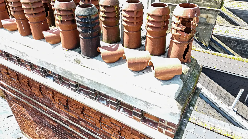 Drone roof survey in Brighton: row of clay chimney pots, some broken