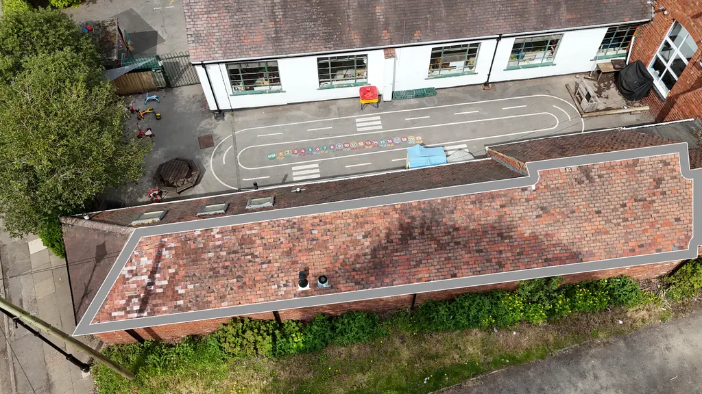 Drone school inspection in Rugby: clay tile school roof outlined beside the playground